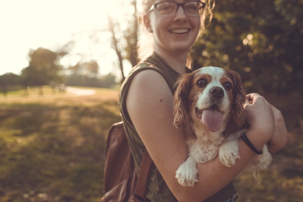 Lady holding her dog in her arms