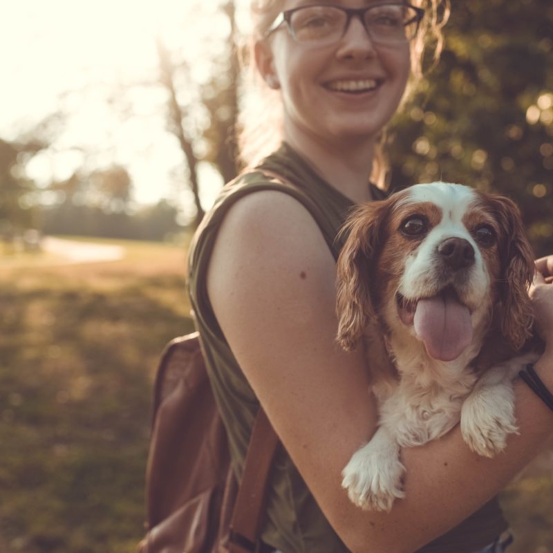 Lady holding her dog in her arms